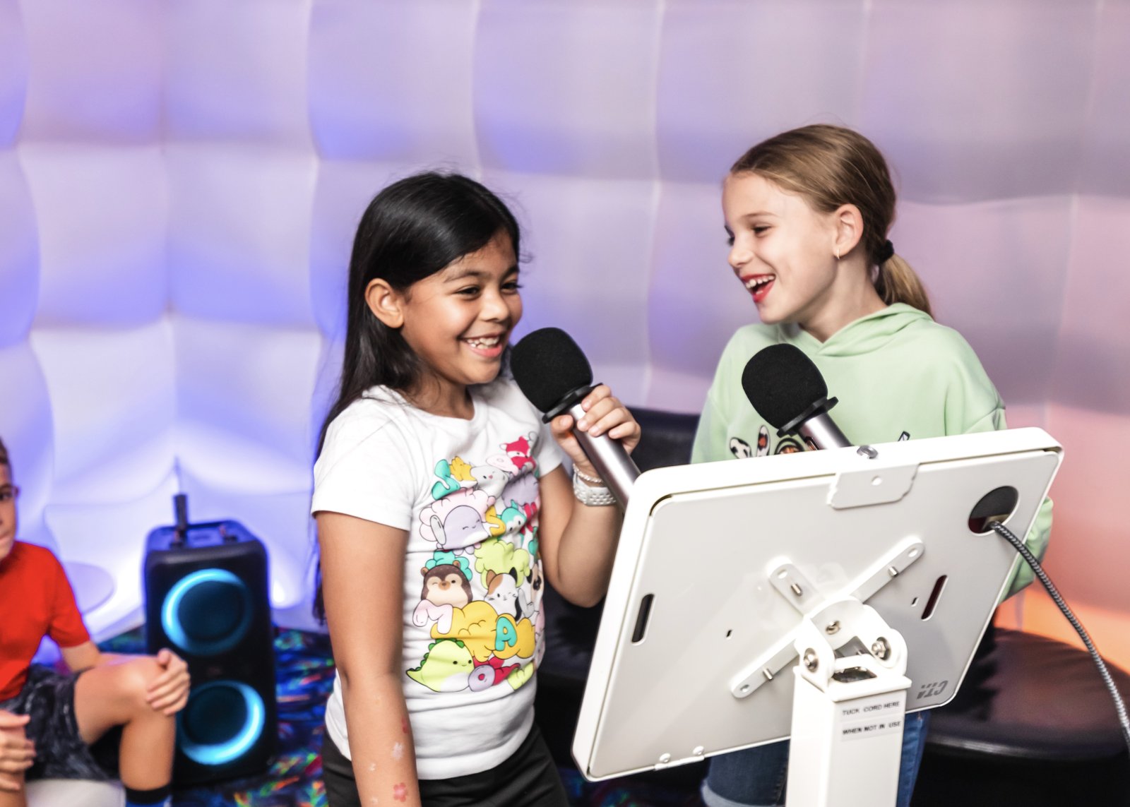 Two kids singing karaoke