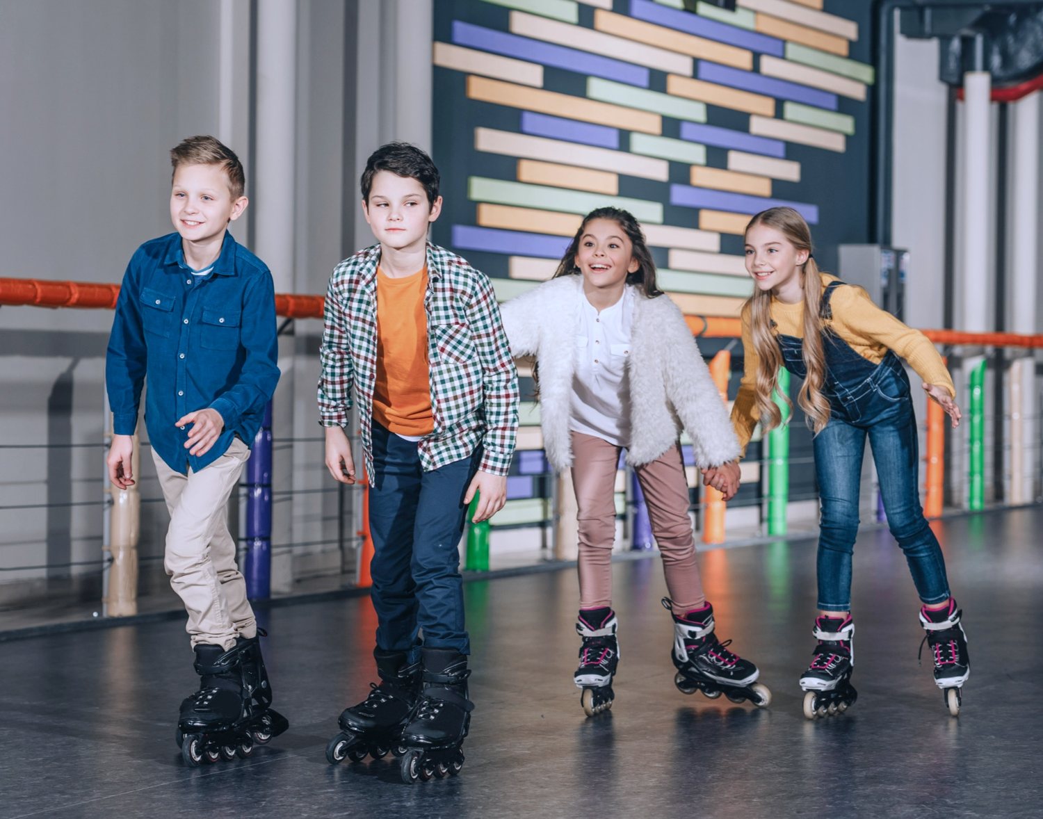 Group of kids lined up on roller skates ready for a Learn to Skate class